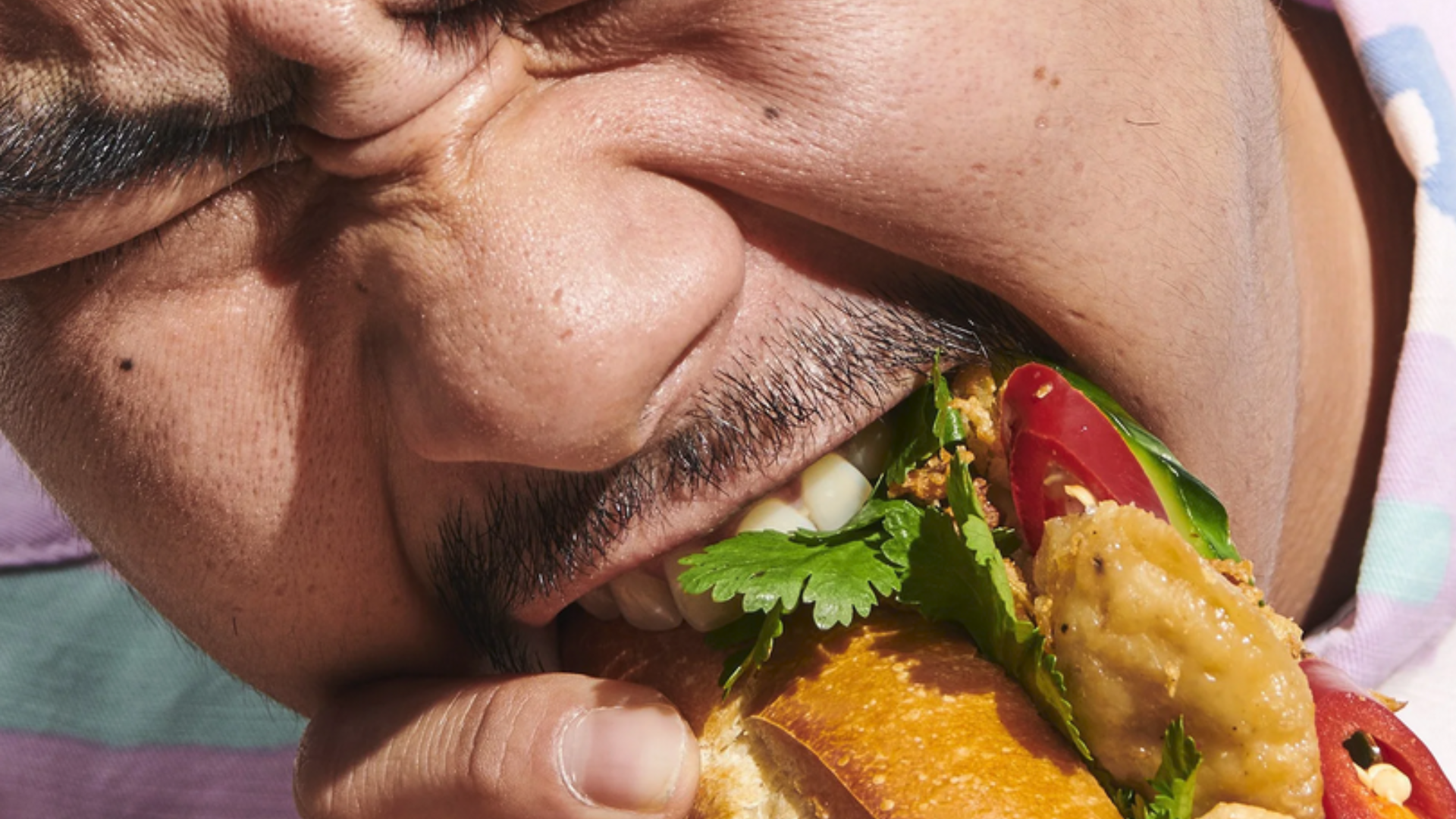 Mann beisst on Banh-mi im An Chay Restaurant